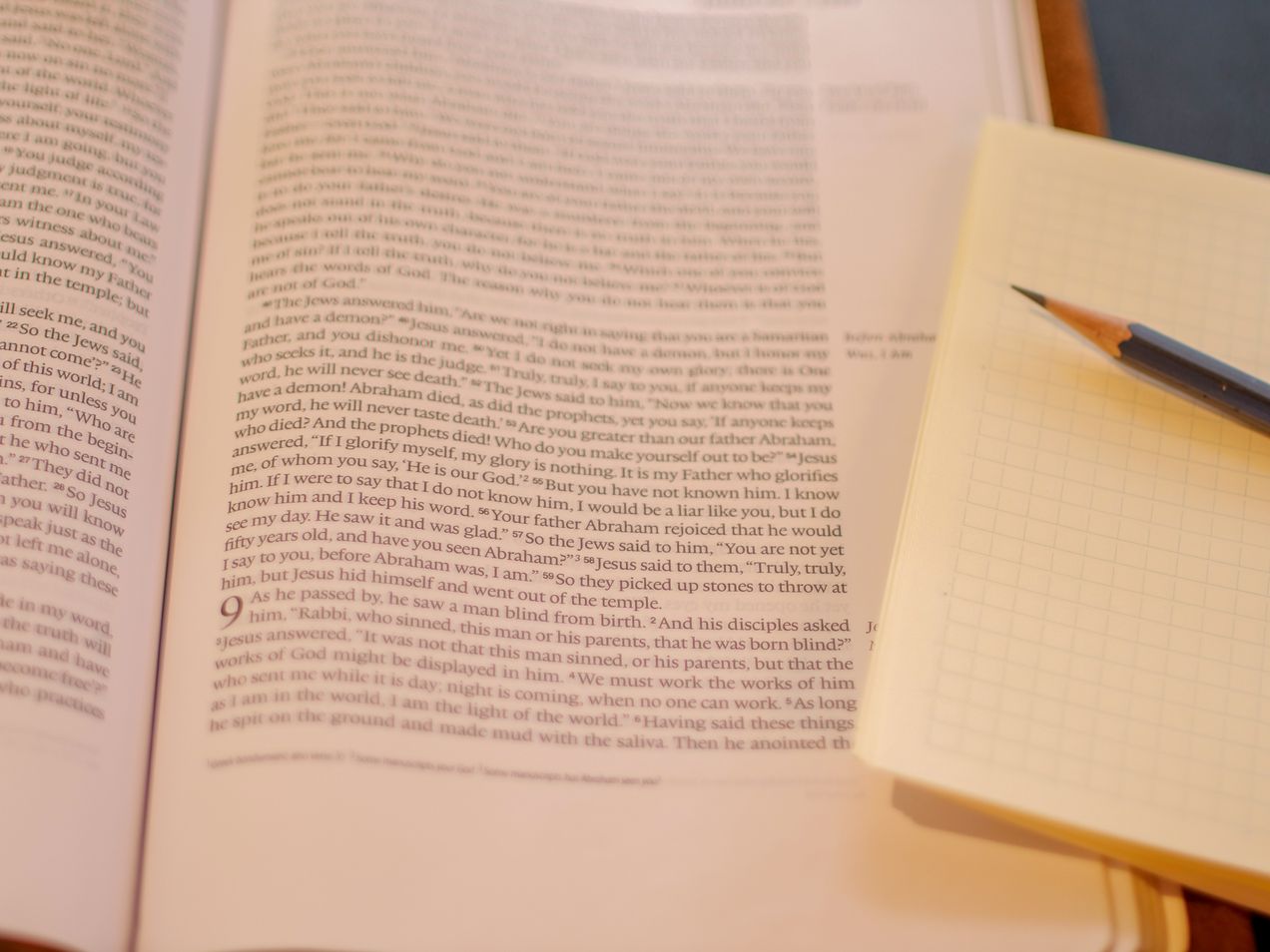 Bible, notebook, and sharpened pencil